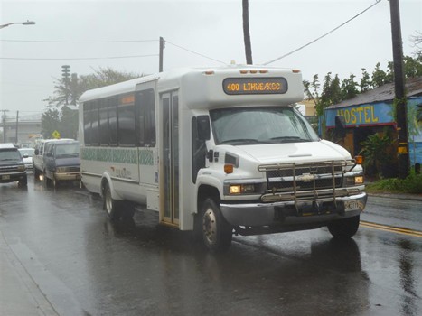 photo of The Kauai Bus driving in the rain